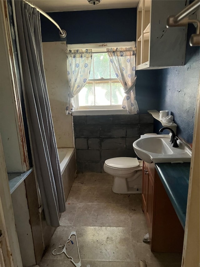 107 Russell St, Liberty Hill, TX 78642 - full bath featuring vanity, shower / bath combination with curtain, and stone finish floors