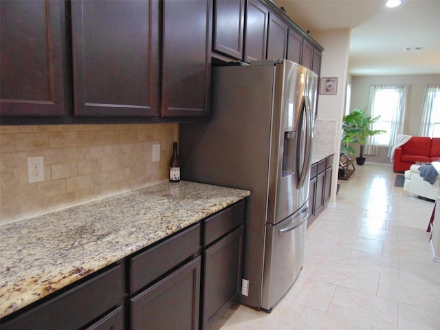 23727 Scotsman Dr, Katy, TX 77493 - kitchen featuring stainless steel fridge, dark brown cabinetry, tasteful backsplash, light stone countertops, and recessed lighting