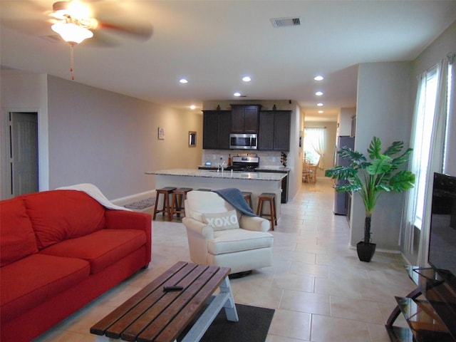 23727 Scotsman Dr, Katy, TX 77493 - living area with recessed lighting, light tile patterned flooring, and a ceiling fan