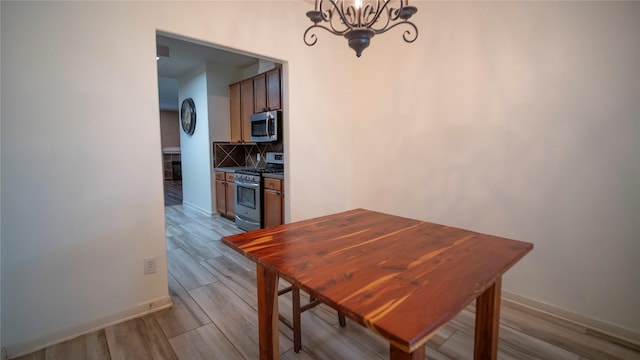 18527 Grove Brook Ln, Cypress, TX 77429 - dining space with a chandelier and wood finished floors