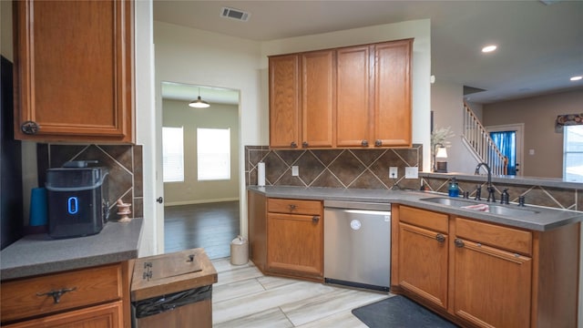 18527 Grove Brook Ln, Cypress, TX 77429 - kitchen with stainless steel dishwasher, backsplash, brown cabinets, recessed lighting, and a peninsula