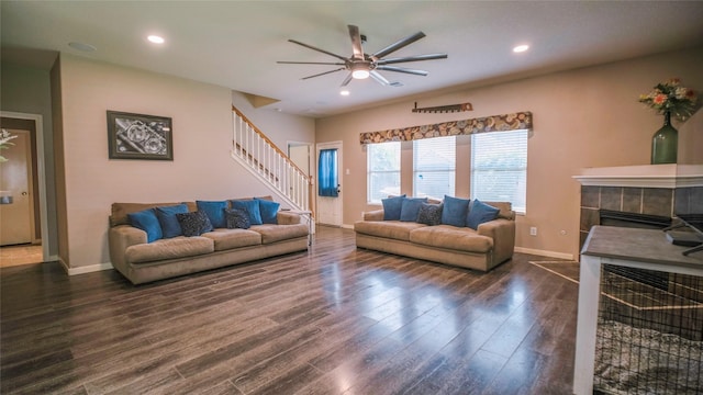 18527 Grove Brook Ln, Cypress, TX 77429 - living room with a ceiling fan, stairway, dark wood finished floors, a tiled fireplace, and recessed lighting