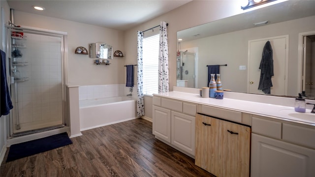 18527 Grove Brook Ln, Cypress, TX 77429 - full bathroom with vanity, a stall shower, a garden tub, wood finished floors, and recessed lighting