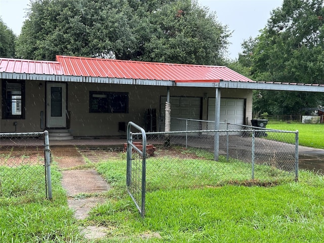 5119 33rd St, Groves, TX 77619 - view of front facade featuring a metal roof, entry steps, and a detached garage