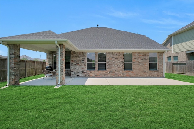 31319 Mallet Cv, Fulshear, TX 77441 - rear view of property featuring roof with shingles, a patio area, a fenced backyard, and brick siding