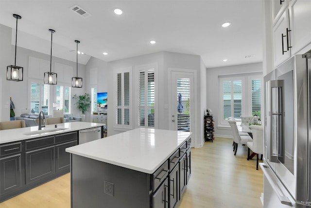 16634 Lake Austin St, Cypress, TX 77433 - kitchen featuring appliances with stainless steel finishes, light wood-style flooring, light countertops, lofted ceiling, and recessed lighting