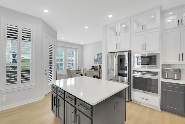 16634 Lake Austin St, Cypress, TX 77433 - kitchen with appliances with stainless steel finishes, light wood finished floors, white cabinets, and recessed lighting