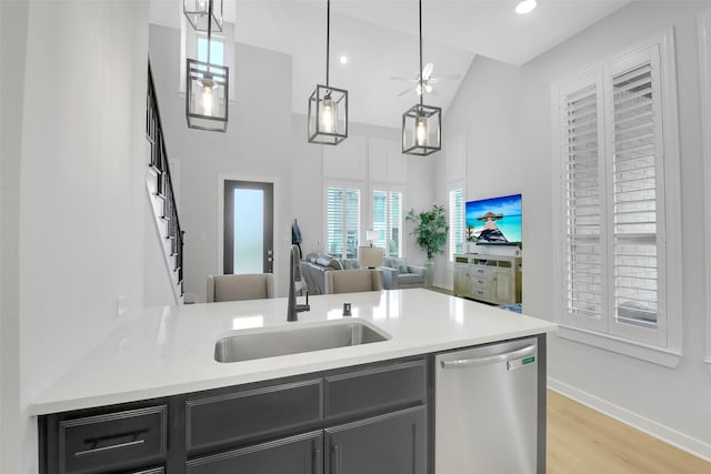 16634 Lake Austin St, Cypress, TX 77433 - kitchen featuring stainless steel dishwasher, light countertops, ceiling fan, light wood-style flooring, and high vaulted ceiling