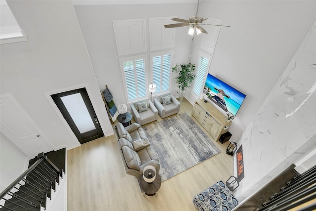 16634 Lake Austin St, Cypress, TX 77433 - living area featuring a towering ceiling, wood finished floors, a ceiling fan, and stairway