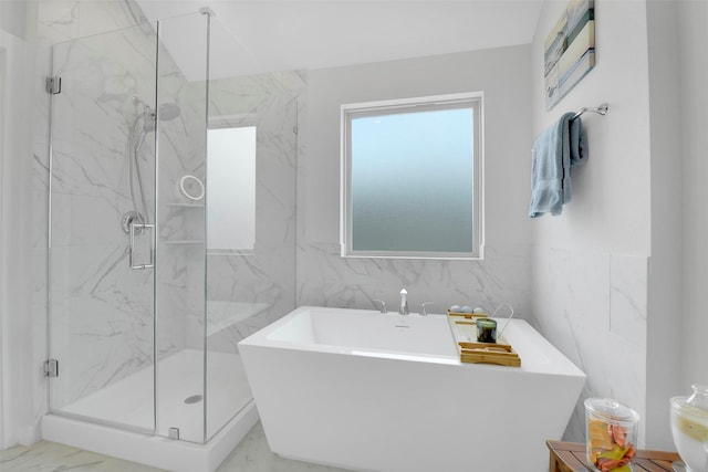 16634 Lake Austin St, Cypress, TX 77433 - bathroom featuring marble finish floors, tile walls, a freestanding tub, and a marble finish shower