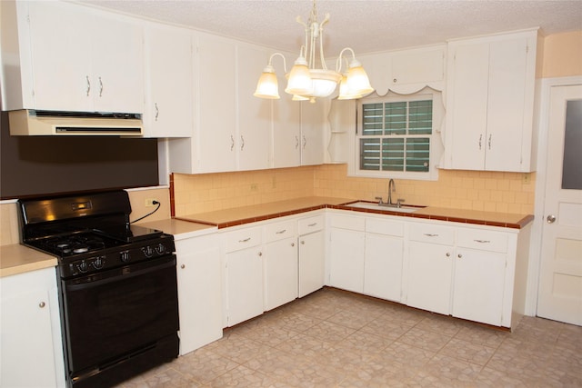 6718 E Bayou Dr, Hitchcock, TX 77563 - kitchen with black range with gas cooktop, range hood, tasteful backsplash, white cabinets, and light countertops