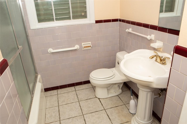 6718 E Bayou Dr, Hitchcock, TX 77563 - bathroom with tile walls, combined bath / shower with glass door, and tile patterned floors