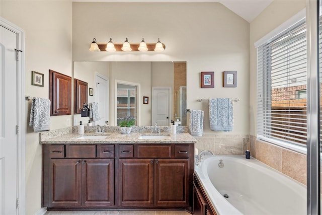 19718 Yellow Hibiscus Ln, Cypress, TX 77433 - bathroom with plenty of natural light, a garden tub, double vanity, and lofted ceiling