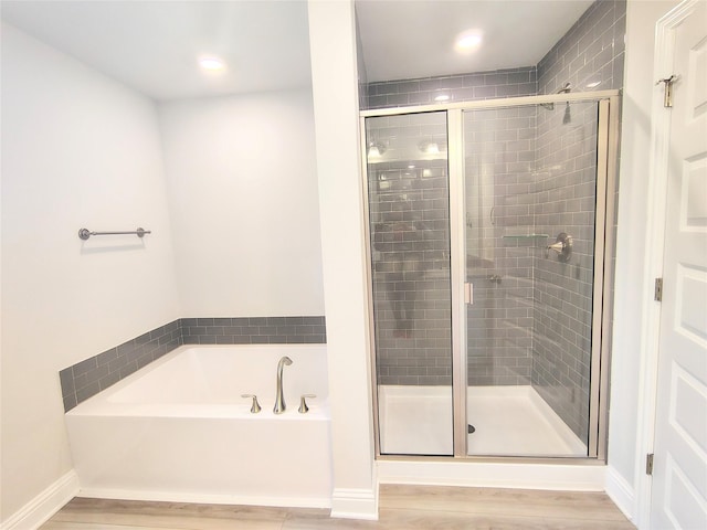 18 Gemstone Ct, Angleton, TX 77515 - bathroom with a garden tub, wood finished floors, a shower stall, baseboards, and recessed lighting