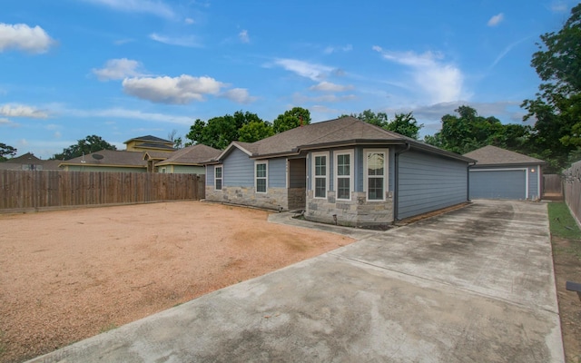 5409 Gold St, Houston, TX 77026 - ranch-style home with a detached garage and stone siding