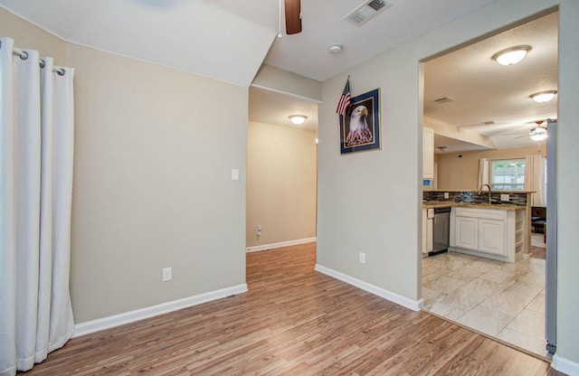 5409 Gold St, Houston, TX 77026 - kitchen with ceiling fan, light wood-style floors, dishwasher, and a peninsula