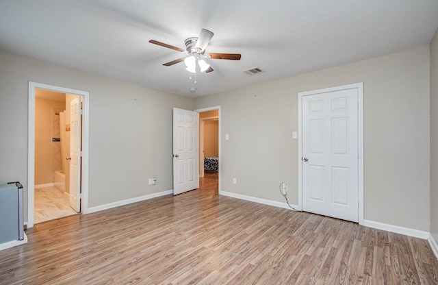 5409 Gold St, Houston, TX 77026 - unfurnished bedroom with light wood-style flooring, ensuite bathroom, and ceiling fan