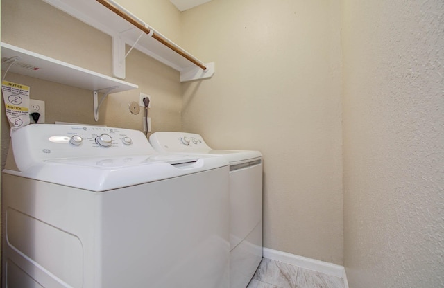 5409 Gold St, Houston, TX 77026 - laundry room featuring independent washer and dryer and light marble finish flooring