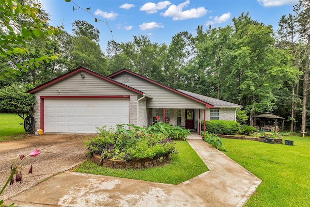 3360 Knob Oaks Dr, Huntsville, TX 77340 - ranch-style house with a gazebo, a front lawn, concrete driveway, a garage, and covered porch