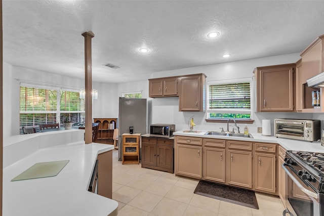 3360 Knob Oaks Dr, Huntsville, TX 77340 - kitchen with appliances with stainless steel finishes, light countertops, a textured ceiling, light tile patterned floors, and recessed lighting