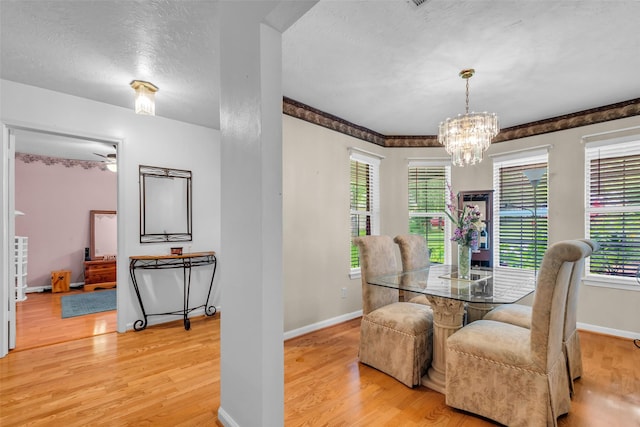3360 Knob Oaks Dr, Huntsville, TX 77340 - dining room with light wood finished floors, healthy amount of natural light, a chandelier, and a textured ceiling