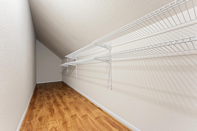 9415 Vista Falls Ct, Richmond, TX 77469 - spacious closet featuring light wood-style flooring and lofted ceiling