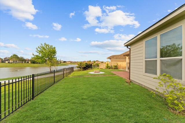 9415 Vista Falls Ct, Richmond, TX 77469 - fenced backyard featuring a water view and a fire pit