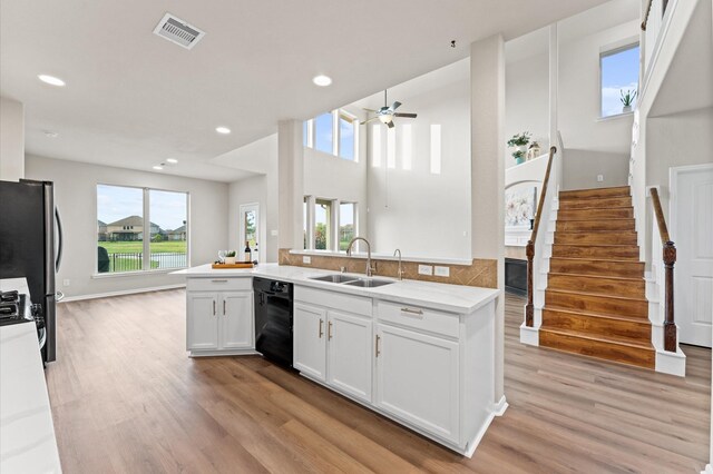 9415 Vista Falls Ct, Richmond, TX 77469 - kitchen featuring dishwasher, light wood-style floors, freestanding refrigerator, a ceiling fan, and white cabinetry