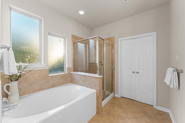 9415 Vista Falls Ct, Richmond, TX 77469 - bathroom featuring a bath, a shower stall, tile patterned flooring, and recessed lighting