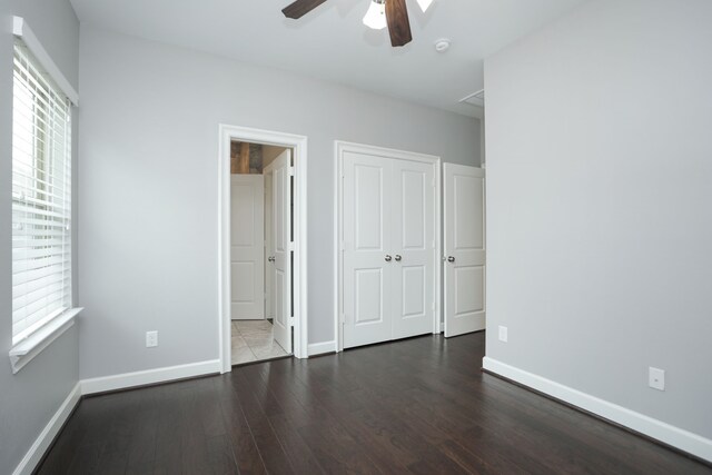 5120 Larkin St, Houston, TX 77007 - unfurnished bedroom with multiple windows, wood finished floors, and a closet