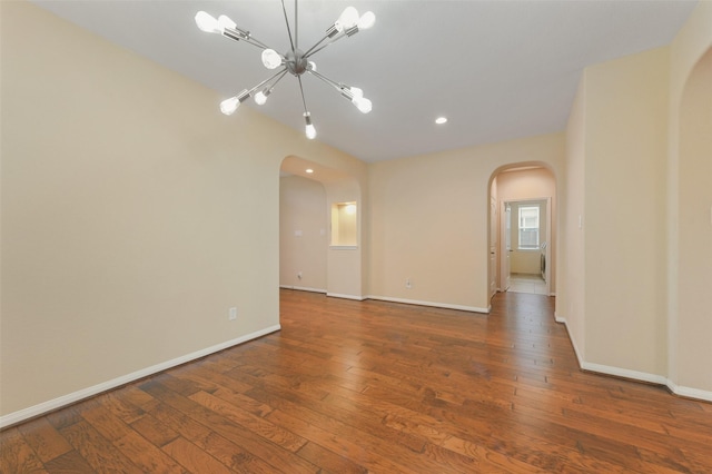 24030 Tirso River Ct, Katy, TX 77493 - spare room featuring arched walkways, a chandelier, hardwood / wood-style flooring, and recessed lighting