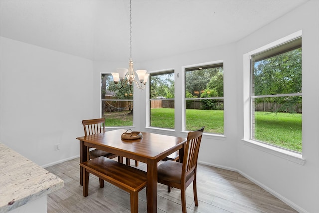 2403 Mustang Dr, Conroe, TX 77384 - dining room with healthy amount of natural light, a chandelier, and light wood-type flooring