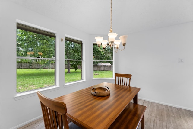 2403 Mustang Dr, Conroe, TX 77384 - dining area with healthy amount of natural light, a chandelier, and light wood-style flooring
