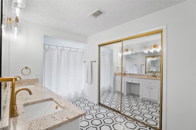 2403 Mustang Dr, Conroe, TX 77384 - full bath featuring double vanity, a textured ceiling, and a shower with shower curtain