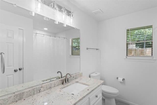 2403 Mustang Dr, Conroe, TX 77384 - full bath with vanity, tile patterned floors, a textured ceiling, and curtained shower