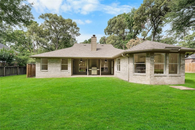 2403 Mustang Dr, Conroe, TX 77384 - rear view of house featuring a ceiling fan, a chimney, a patio area, and brick siding