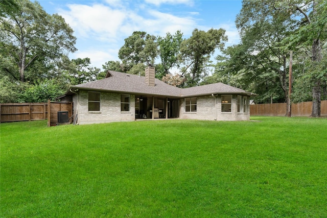2403 Mustang Dr, Conroe, TX 77384 - rear view of house with a chimney, brick siding, a fenced backyard, and roof with shingles
