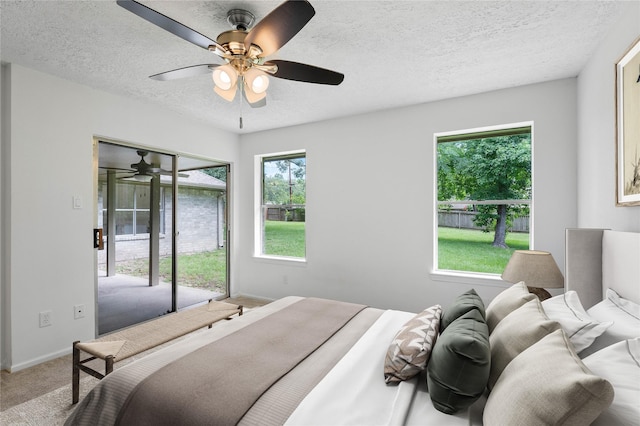 2403 Mustang Dr, Conroe, TX 77384 - bedroom featuring carpet, a textured ceiling, access to exterior, and a ceiling fan