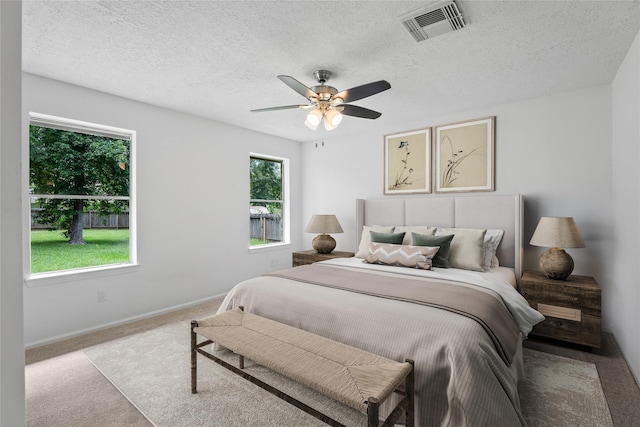 2403 Mustang Dr, Conroe, TX 77384 - bedroom with carpet flooring, a textured ceiling, and ceiling fan