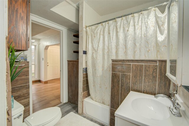 911 Wooding St, Houston, TX 77011 - full bath with wood finished floors, vanity, and shower / bathtub combination with curtain