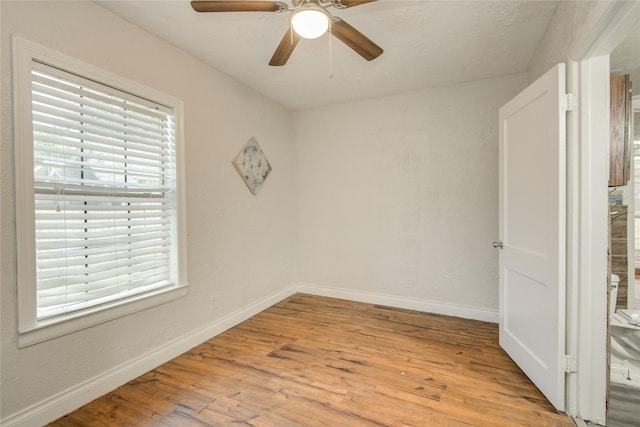911 Wooding St, Houston, TX 77011 - unfurnished room with healthy amount of natural light, wood finished floors, and ceiling fan