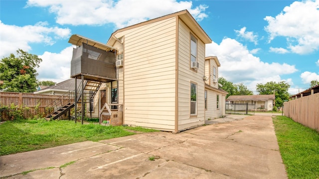 911 Wooding St, Houston, TX 77011 - back of property featuring stairway, a patio area, and cooling unit