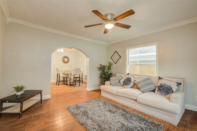 911 Wooding St, Houston, TX 77011 - living area with arched walkways, crown molding, wood finished floors, and ceiling fan