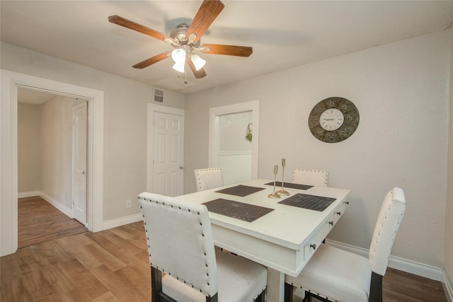 911 Wooding St, Houston, TX 77011 - dining room with wood finished floors and ceiling fan