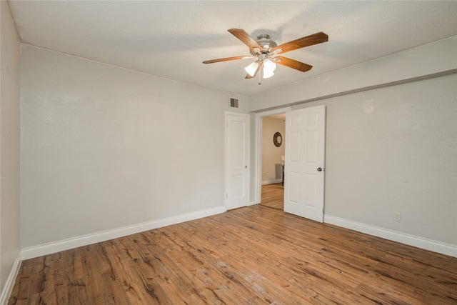 911 Wooding St, Houston, TX 77011 - empty room with wood finished floors and ceiling fan