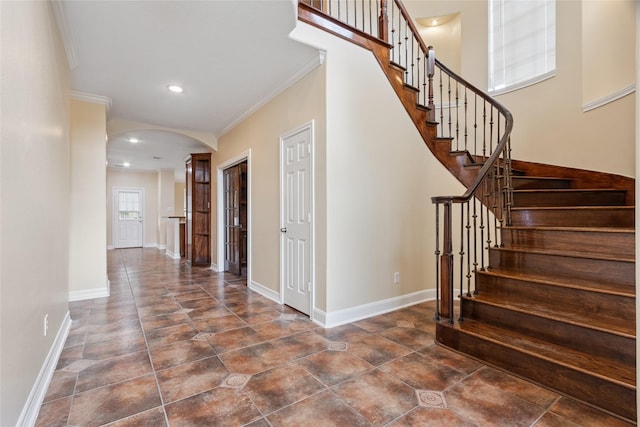 8666 Pearl Point St, Houston, TX 77044 - staircase featuring arched walkways, crown molding, and recessed lighting
