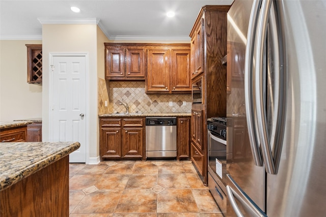 8666 Pearl Point St, Houston, TX 77044 - kitchen with appliances with stainless steel finishes, crown molding, backsplash, light stone counters, and brown cabinets