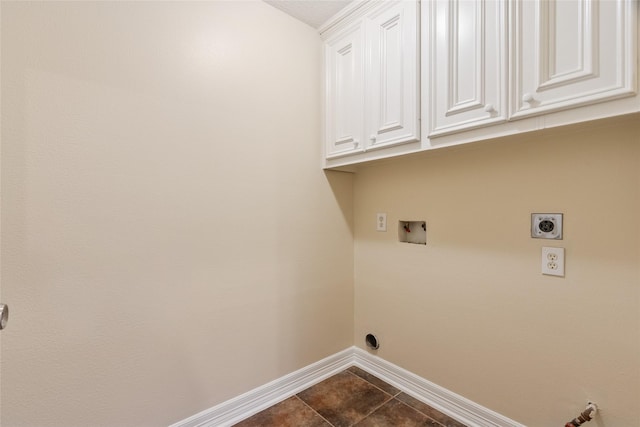 8666 Pearl Point St, Houston, TX 77044 - laundry room featuring cabinet space, washer hookup, dark tile patterned flooring, and electric dryer hookup