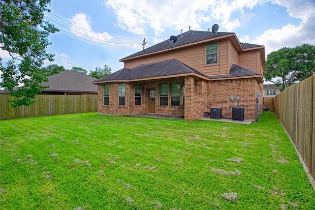 8666 Pearl Point St, Houston, TX 77044 - back of property featuring brick siding, a patio, a fenced backyard, and a shingled roof