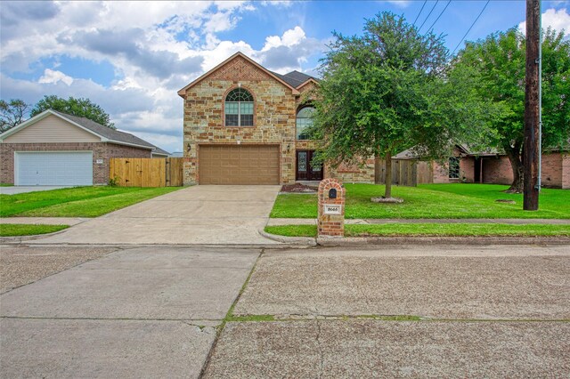 8666 Pearl Point St, Houston, TX 77044 - traditional-style house with brick siding, concrete driveway, and a garage